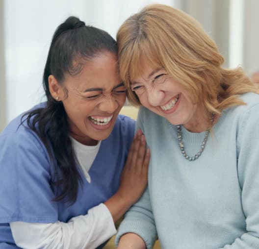 caregiver and senior laughing