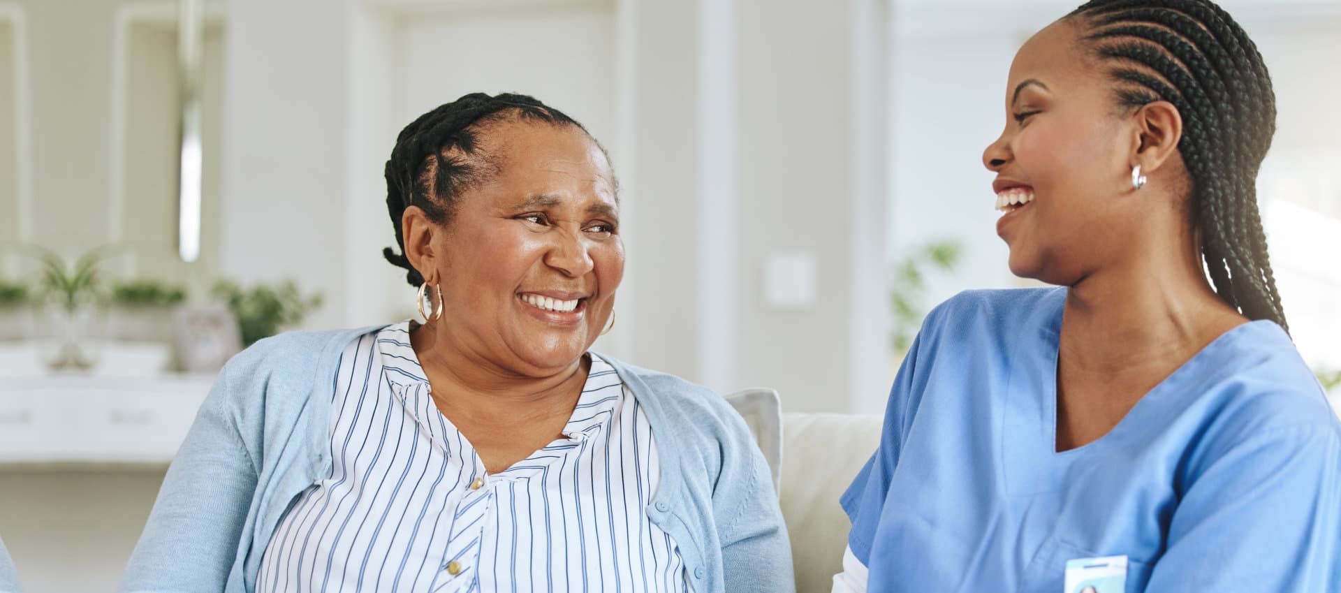 nurse and laughing together for support, healthcare and happiness at retirement home.