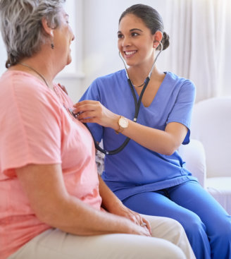 caregiver guiding senior on reading