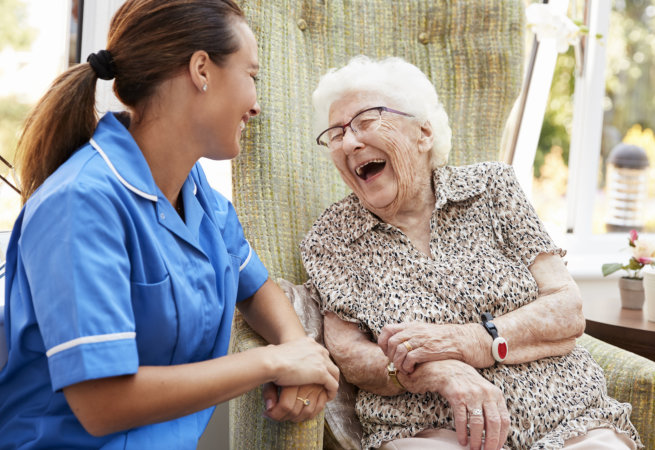 caregiver and senior smiling