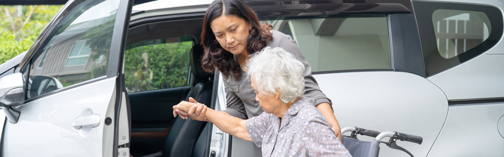 caregiver assisting senior for her medical appointment